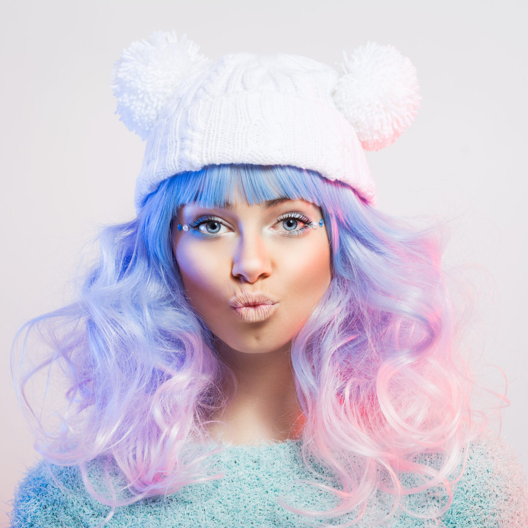 Cute young fashion woman with pastel purple and pink hair and makeup